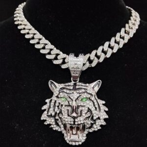 Silberne Halskette mit funkelndem Tigerkopf-Anhänger, verziert mit grünen Augen auf schwarzem Hintergrund.